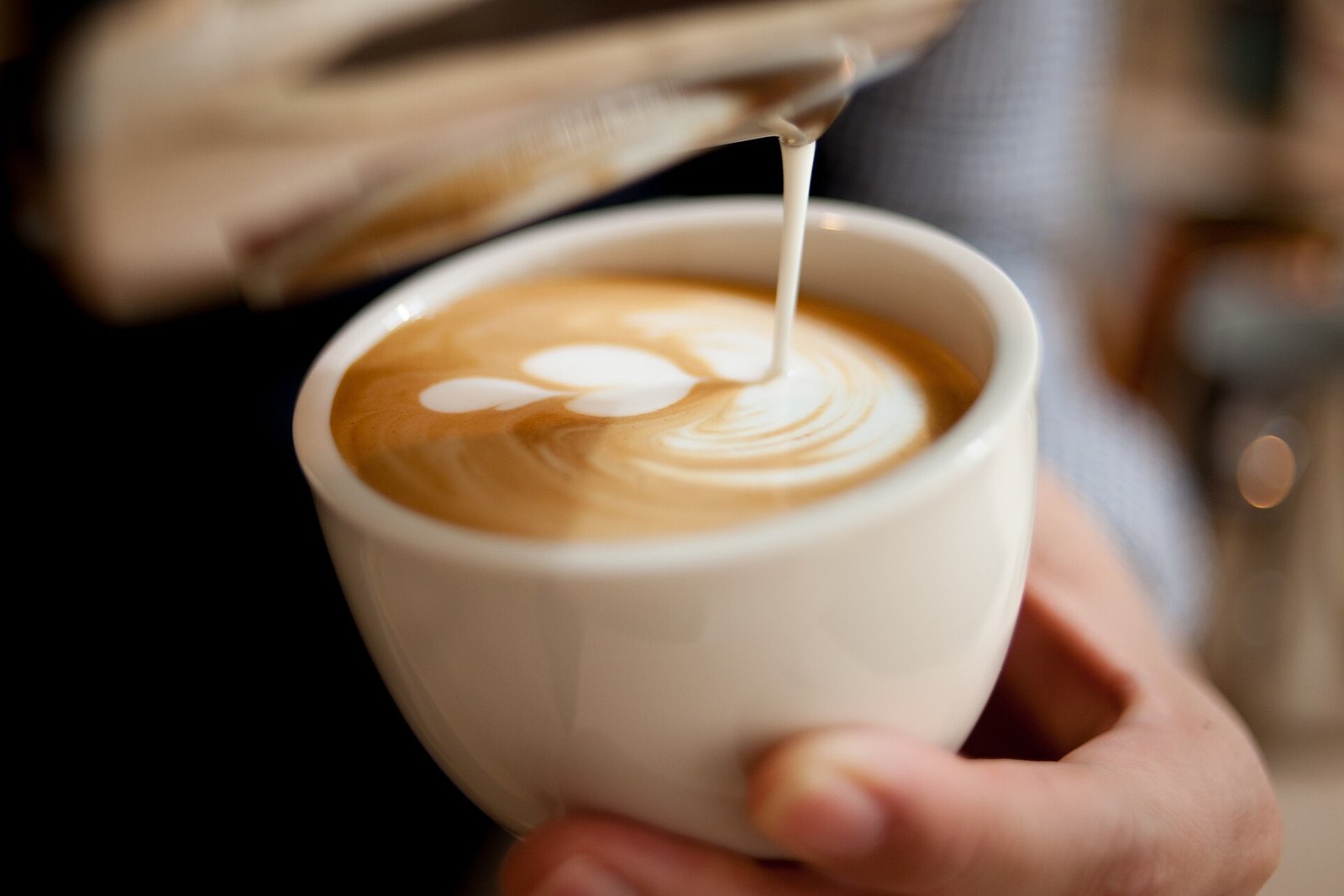 Flat white with fine white latte art poured across the surface