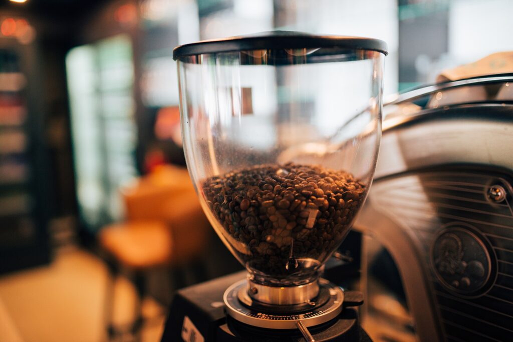 Coffee grinder hopper filled with freshly roasted coffee beans