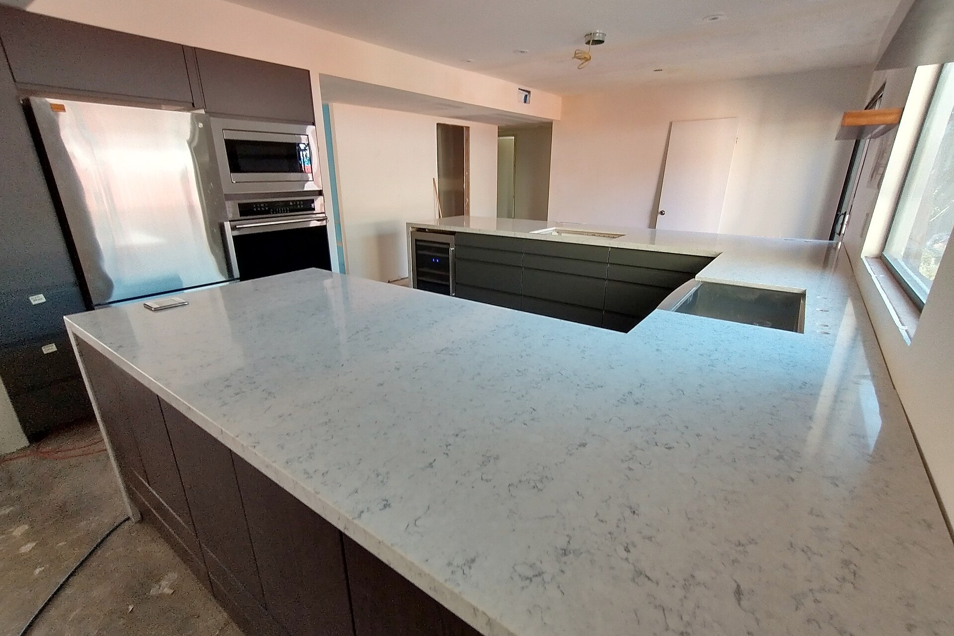 Installed kitchen with new cabinets, worktops and appliances during final renovation work