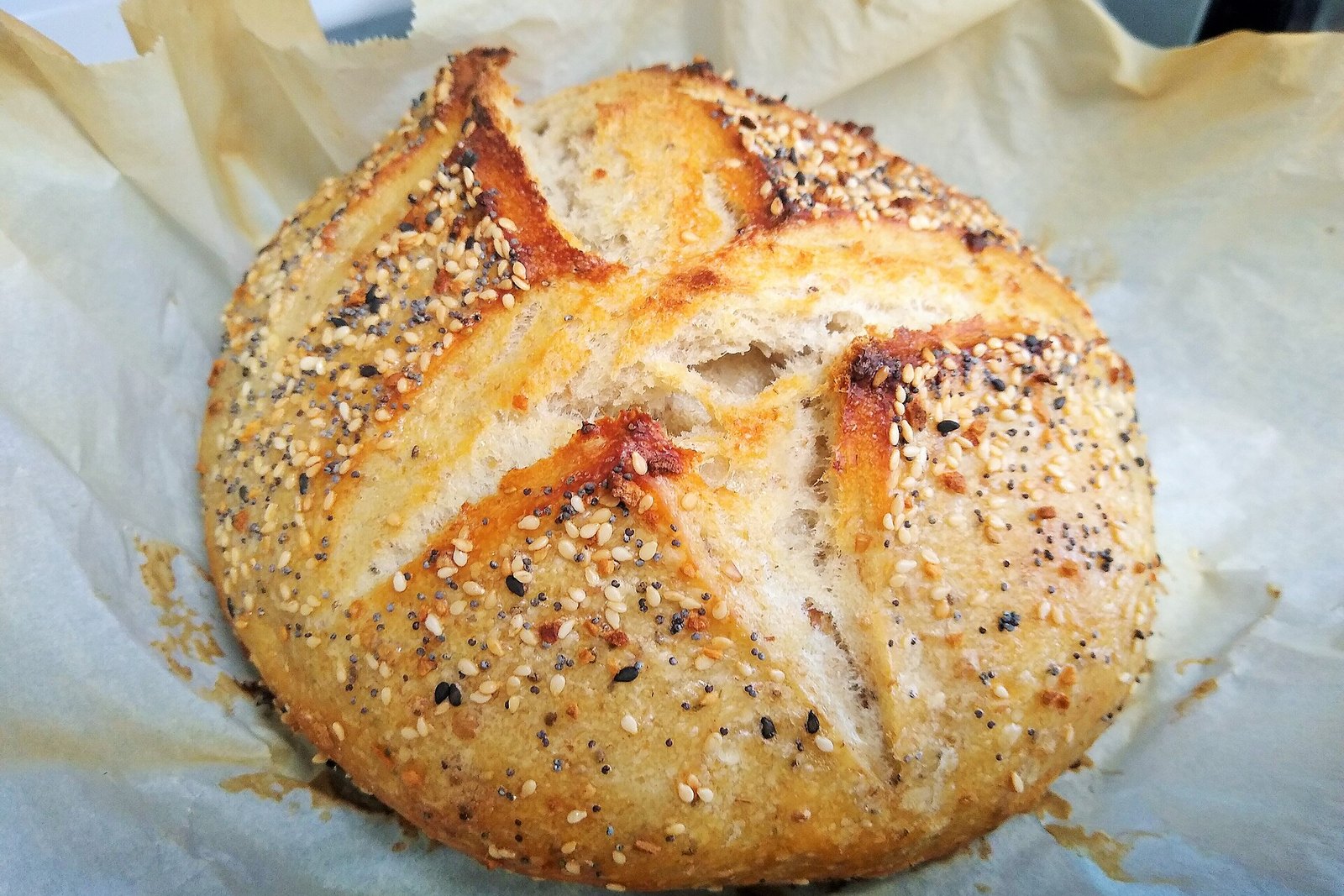 Round loaf of sourdough bread with a crisp golden crust