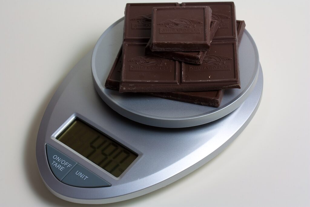 Digital kitchen scale being used to weigh ingredients