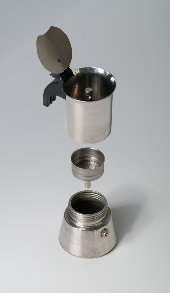 Moka pot components floating, illustrating a daily-use detail in moka pot buying guide for gas and induction hobs